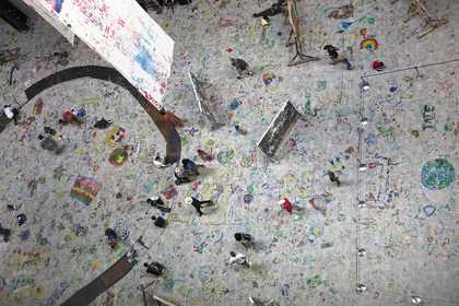 A birds eye view of the floor of the turbine hall during Mega Please Draw Freely, covered with drawings 
