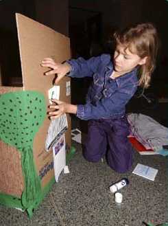 Kid adding details to her house