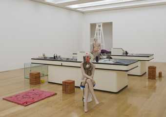 Cathy Wilkes I Give you All My Money 2008 installation view of mannequins positioned around kitchen sink units