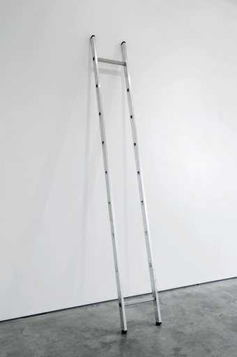 Ceal Floyer Ladder minus 2to 8 2010 photograph of an aluminium ladder leaning against a white gallery wall with all the rungs missing apart from the top rung