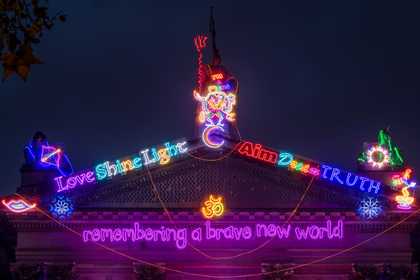 The top of Tate Britain's facade lit up with neon lights for Chila Kumari Singh Burman's commission 