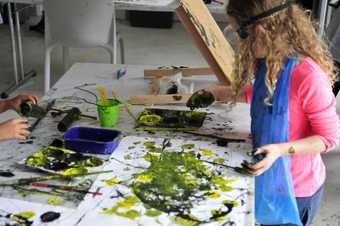 Child experimenting with textured paint techniques