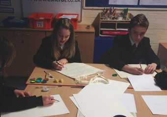 School children drawing their designs