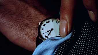 film still of Christian Marclay The Clock 2010 showing the top half of a clock face