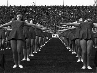 Marta Popivoda, Yugoslavia, How Ideology Moved Our Collective Body 2013 Film still showia black and white photo of cheerleaders 