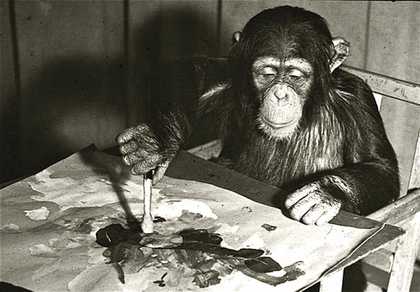 A black and white photograph of Congo the chimp painting at London Zoo.