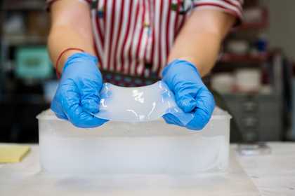 Someone holding gel that will clean artwork 