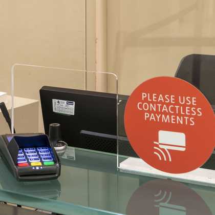 Card machine and a sign saying please use contactless payments.