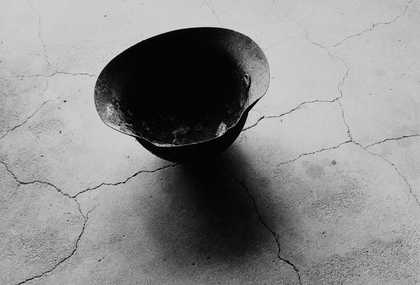 Shomei Tomatsu, Iron helmet with parts of human skull attached. Near the hypocenter, 1963