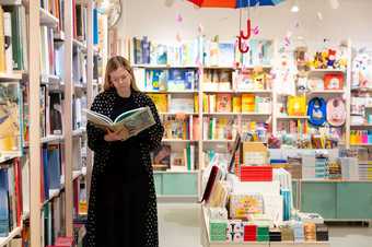 A person stands to look at a book in the Tate St Ives shop