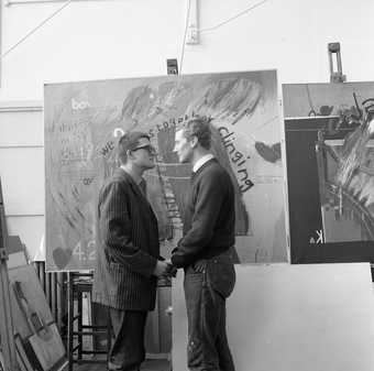 David Hockney and Derek Boshier, students together at the Royal College of Art from 1959 to 1962, in front of Hockney's We Two Boys Together Clinging, photographed by Geoffrey Reeve in 1962