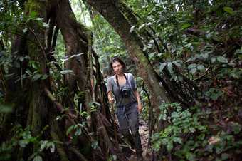 An image of Diana walking through a lush forest