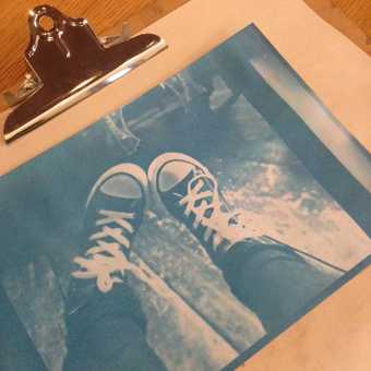 A cyanotype print of a kid's feet