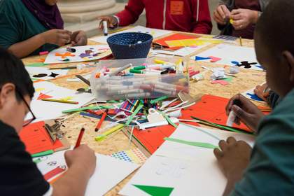 children colour in with felt tips on a table