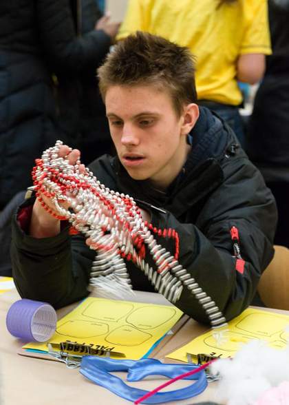 A child sits at a table in Tate Britain and creates an abstract sculpture