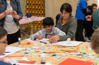 Children and workshop assistants create paper work
