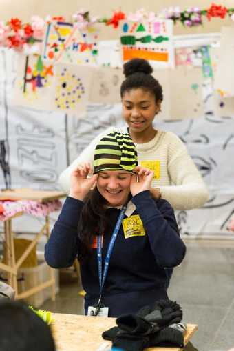 A woprkshop partipant tries on a stripey hat at the Tate Britain event 'Diggin' the Gallery'