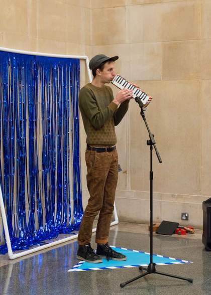 A keyboard player plays in Tate Britain