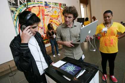 Young person experimenting with digital programme on laptop and ipad