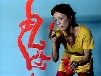 Photograph of the artist Joan Jonas painting in 1984