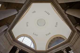 upshot of a building showing text on the ceiling