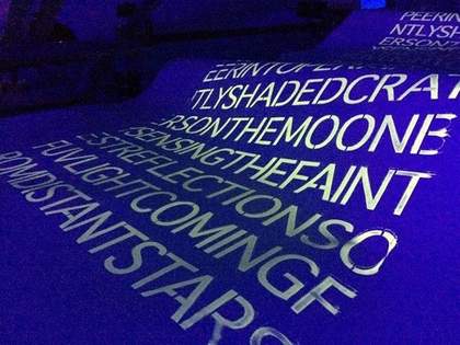 Typed Text run down a rolled blue sheet