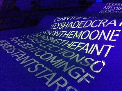 Typed Text run down a rolled blue sheet