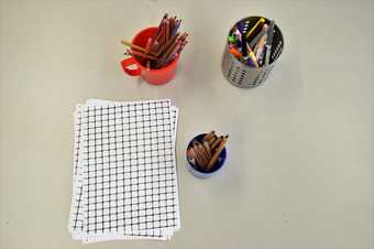 Grid paper and pencil crayons