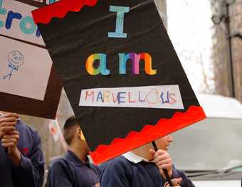 A student holding his 'I Am Marvellous' placard, taken at I Am Tate Exchange Festival 2019