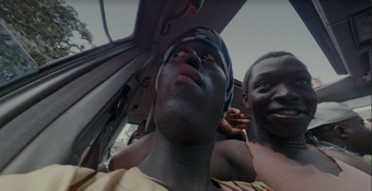 A group of people sitting in a car shot from a low angle