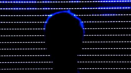 Ed Atkins A Tumour In English image of a sillhouette of a persons head against the rows of lights