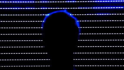 Ed Atkins A Tumour In English image of a sillhouette of a persons head against the rows of lights