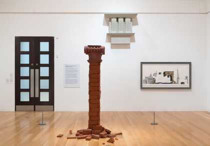 Installation view of Edward Allington and Pablo Bronstein showing a pillar and an architectural picture on the gallery wall