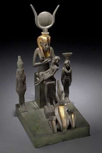 Copper alloy group showing Isis sucklig Horus-the-child, flanked by figures of Mut and Nephthys, with three uraei at front