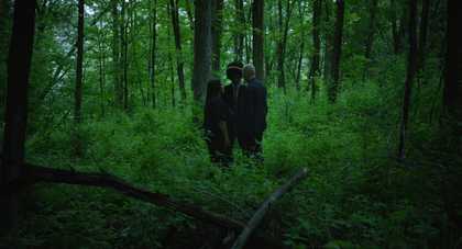 Three people in the forest