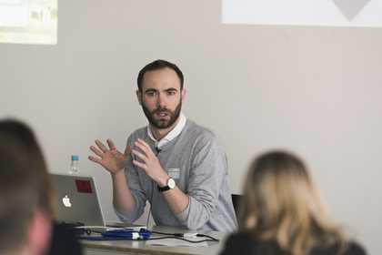 A speaker addresses the audience