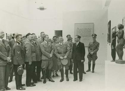 Exhibition co ordinator Hartmut Pistauer leads Nazi party officials through the Degenerate Art Exhibition at the Kunst Palast in Dusseldorf 1938 photograph of men in uniforms looking at art