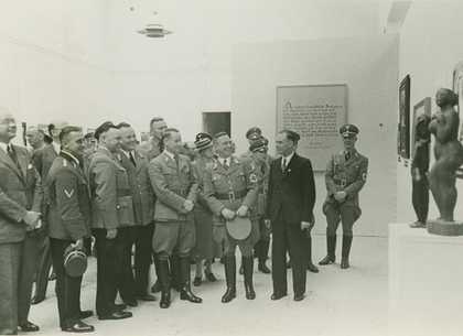 Exhibition co ordinator Hartmut Pistauer leads Nazi party officials through the Degenerate Art Exhibition at the Kunst Palast in Dusseldorf 1938 photograph of men in uniforms looking at art
