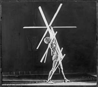 A dancer poses during Oskar Schlemmer’s Stick Dance, part of his Triadic Ballet 1926–9 (reproduced in 1980)