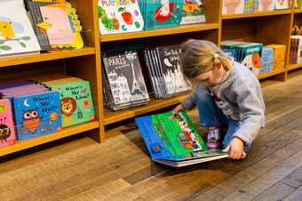 Children enjoying the books in the Turbine Hall shop at Tate Modern