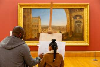 Visitor looking at paintings in the Turner Collection at Tate Britain