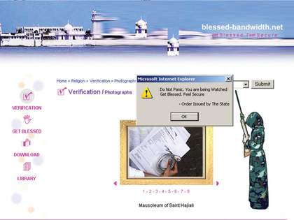 A webpage featuring a menu of actions, including ‘Get Blessed’, a cartoon of a person in a hooded camouflage robe holding a large gun, and a Microsoft Internet Explorer pop-up window that says ‘Do Not Panic. You are being Watched. Get Blessed. Feel Secure