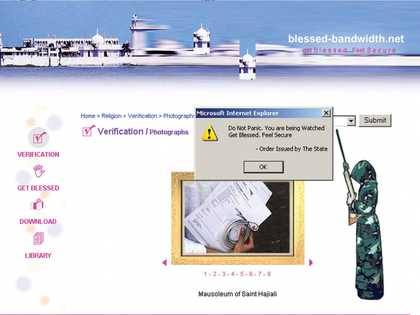 A webpage featuring a menu of actions, including ‘Get Blessed’, a cartoon of a person in a hooded camouflage robe holding a large gun, and a Microsoft Internet Explorer pop-up window that says ‘Do Not Panic. You are being Watched. Get Blessed. Feel Secure