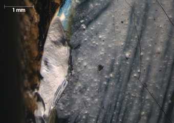 Micrograph showing damage at left edge at site of cross-sections