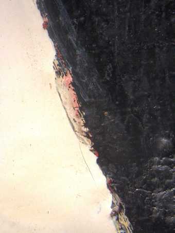 Detail of left edge of ball, showing glimpses of red and pink paint