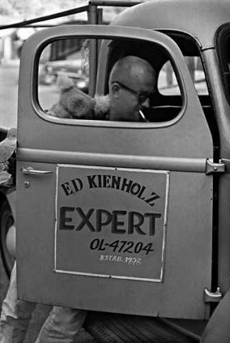 Fig.15 Black-and-white photograph of Edward Kienholz getting into hi pick-up truck, on the door of which is printed: Ed Kienholz, EXPERT