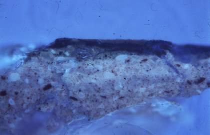 Fig.16 Cross-section though mustard yellow decoration on the suit of armour at the left edge, photographed at x200 magnification in ultraviolet light.