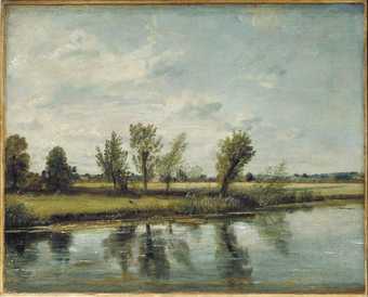A scene showing a stretch of water in the foreground, trees behind it and in the distance.