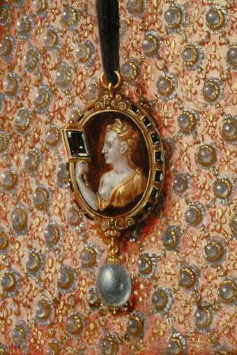  Fig.22 Detail of the patterning of the dress and the cameo brooch