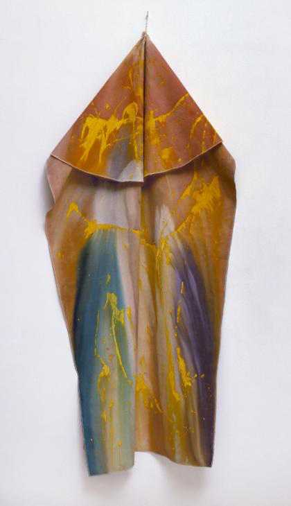 Photograph of a painting on a rectangular sheet of cotton duck canvas that hangs vertically from a single point on the wall from a tied leather string; dominated by diffuse pink and orange tones, bleeding into areas of blue and turquoise at the bottom.